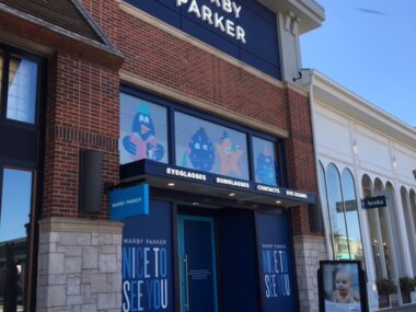 Warby Parker sign installed on building