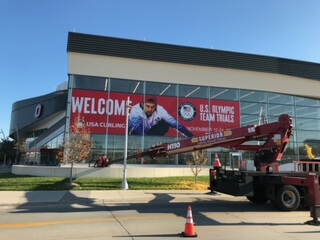 Sign installation for Curling trials at Baxter Arena