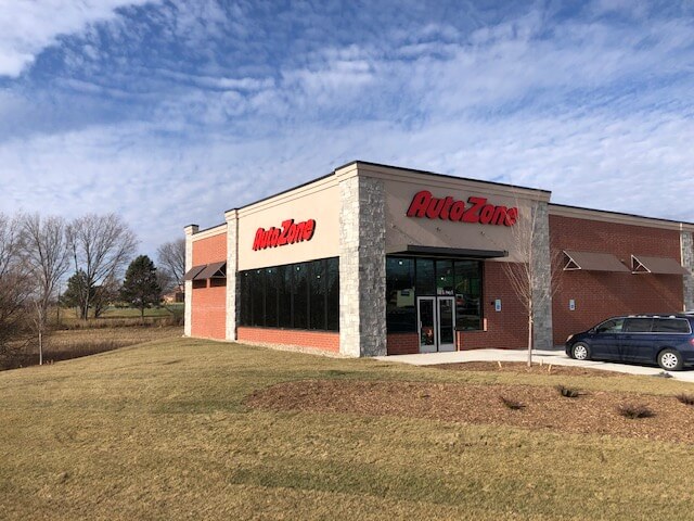 Auto Zone sign installation on building